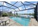 Inviting screened-in pool and patio with a scenic lake view, ideal for outdoor relaxation at 10112 Canaveral Cir, Sarasota, FL 34241