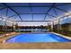 Private screened pool overlooking a serene lake, perfect for relaxation at 10112 Canaveral Cir, Sarasota, FL 34241