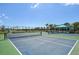 Community tennis courts with shelter, nets, and green and blue surface at 10112 Canaveral Cir, Sarasota, FL 34241