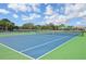 Community tennis courts with shelter, nets, and green and blue surface at 10112 Canaveral Cir, Sarasota, FL 34241