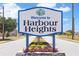 Welcome to Harbour Heights sign on a sunny day, inviting you to explore this lovely neighborhood at 1041 Harbour Drake Dr, Punta Gorda, FL 33983