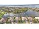 Scenic aerial shot of residences along a lake, showcasing pools and meticulous landscaping at 13096 N Marsh Dr, Port Charlotte, FL 33953