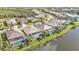 Scenic aerial view of a lakeside property with a screened pool and lush landscaping at 13096 N Marsh Dr, Port Charlotte, FL 33953