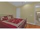 This is a second bedroom with wood floors and an ensuite bathroom at 13096 N Marsh Dr, Port Charlotte, FL 33953