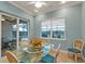 Light and bright dining room with a glass table, seating for four, and views of the pool at 13096 N Marsh Dr, Port Charlotte, FL 33953