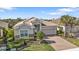 Beautiful home with a tiled roof, manicured landscaping, and a brick paved driveway at 13096 N Marsh Dr, Port Charlotte, FL 33953