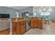 Open-concept kitchen featuring granite countertops, stainless steel appliances, and warm wood cabinetry at 13096 N Marsh Dr, Port Charlotte, FL 33953