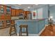 Kitchen featuring a breakfast bar, light blue walls, tile floors, and pendant lights at 13096 N Marsh Dr, Port Charlotte, FL 33953