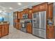 Modern kitchen featuring stainless steel appliances, tiled backsplash, and warm wood cabinetry at 13096 N Marsh Dr, Port Charlotte, FL 33953