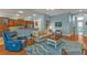 Inviting living room flows to kitchen, featuring hardwood floors, blue walls, and neutral toned furniture at 13096 N Marsh Dr, Port Charlotte, FL 33953