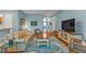 Comfortable living room with hardwood floors, blue walls, and neutral toned furniture at 13096 N Marsh Dr, Port Charlotte, FL 33953