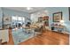 Bright and airy living room with hardwood floors, open concept, and view of the screened in patio at 13096 N Marsh Dr, Port Charlotte, FL 33953
