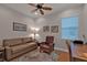 This home office has wood floors, a ceiling fan, and plenty of light at 13096 N Marsh Dr, Port Charlotte, FL 33953