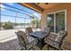 Enjoy this screened-in patio with four chairs, a fire pit, and gorgeous lake views at 13096 N Marsh Dr, Port Charlotte, FL 33953