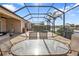 Beautiful screened-in patio dining area that overlooks the lake at 13096 N Marsh Dr, Port Charlotte, FL 33953