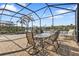 Spacious screened-in patio with dining set and lake views at 13096 N Marsh Dr, Port Charlotte, FL 33953