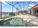 A serene view of screened-in pool and patio area with beautiful lake views at 13096 N Marsh Dr, Port Charlotte, FL 33953