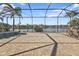 View of the lake from the expansive screened lanai featuring brick pavers, a pool, and outdoor seating at 13096 N Marsh Dr, Port Charlotte, FL 33953