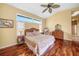 Bedroom featuring gleaming hardwood floors and abundant natural light from a large window at 1336 Casey Key Dr, Punta Gorda, FL 33950