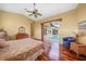 Primary bedroom showcasing a ceiling fan, wood flooring, and private sliding door to pool at 1336 Casey Key Dr, Punta Gorda, FL 33950