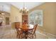 Cozy dining room featuring a charming chandelier and a classic wooden table set at 1336 Casey Key Dr, Punta Gorda, FL 33950