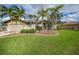 Charming home featuring lush landscaping and a well-manicured front lawn at 1336 Casey Key Dr, Punta Gorda, FL 33950