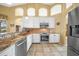Bright kitchen featuring granite countertops, stainless steel appliances and tile flooring at 1336 Casey Key Dr, Punta Gorda, FL 33950