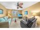 Living room showcasing a comfortable sofa, leather recliner and a ceiling fan at 1336 Casey Key Dr, Punta Gorda, FL 33950