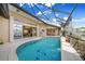 Screened pool with a water view offers seamless indoor-outdoor living in this luxurious home at 1336 Casey Key Dr, Punta Gorda, FL 33950