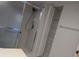 Bathroom featuring a shower with sliding glass doors and a built-in shelf at 1340 San Cristobal Ave # 207, Punta Gorda, FL 33983