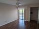 Bedroom features hardwood floors, ceiling fan, sliding glass door to patio, and closet at 1340 San Cristobal Ave # 207, Punta Gorda, FL 33983