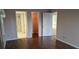 Bedroom view showcasing hardwood floors, closet, bathroom, and additional room entrance at 1340 San Cristobal Ave # 207, Punta Gorda, FL 33983