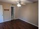 Cozy bedroom featuring wood floors, a ceiling fan, and a doorway to the bathroom at 1340 San Cristobal Ave # 207, Punta Gorda, FL 33983