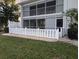 Back condo exterior featuring a white fence and lush landscaping at 1340 San Cristobal Ave # 207, Punta Gorda, FL 33983