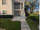 Inviting condo exterior with well-maintained landscaping and a pathway to the entrance at 1340 San Cristobal Ave # 207, Punta Gorda, FL 33983