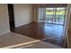 Bright living room featuring wood floors that transition into a tile kitchen area and a sliding door to outdoor seating at 1340 San Cristobal Ave # 207, Punta Gorda, FL 33983