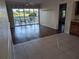 Bright living room featuring wood floors that transition into a tile kitchen area and a sliding door to outdoor seating at 1340 San Cristobal Ave # 207, Punta Gorda, FL 33983