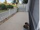 Open patio with a view of the manicured lawn and white picket fence at 1340 San Cristobal Ave # 207, Punta Gorda, FL 33983