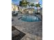 Inviting community pool area with lounge chairs, patio seating, and tropical landscaping at 1340 San Cristobal Ave # 207, Punta Gorda, FL 33983
