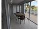 Relaxing screened patio featuring a tile floor, table, and chairs with golf course view at 1340 San Cristobal Ave # 207, Punta Gorda, FL 33983