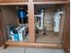 View of the under-sink cabinet reveals a garbage disposal and a water filter at 1340 San Cristobal Ave # 207, Punta Gorda, FL 33983