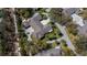 An aerial view of the house shows the layout, large driveway, landscaping, and neighborhood at 1355 Red Oak Ln, Port Charlotte, FL 33948