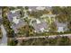 This aerial view showcases the property's placement in a quiet, tree-lined neighborhood at 1355 Red Oak Ln, Port Charlotte, FL 33948