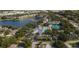 Aerial view of community showing pool, tennis courts, pond, and landscaping at 1355 Red Oak Ln, Port Charlotte, FL 33948