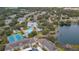 Aerial view of community highlighting pool, tennis courts, pond, beautiful landscaping, and housing at 1355 Red Oak Ln, Port Charlotte, FL 33948