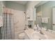 Well-lit bathroom with a shower and tub combination and ample storage at 1355 Red Oak Ln, Port Charlotte, FL 33948