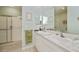 Bathroom featuring double sinks with modern fixtures, ample lighting, and a walk-in shower at 1355 Red Oak Ln, Port Charlotte, FL 33948