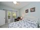 Bright bedroom with a ceiling fan, a queen-sized bed and natural light from the window at 1355 Red Oak Ln, Port Charlotte, FL 33948