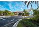 Inviting community clubhouse entrance with well-kept landscaping and an American flag waving at 1355 Red Oak Ln, Port Charlotte, FL 33948