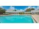 Beautiful community pool with a large sundeck and inviting lounge chairs, perfect for relaxation and social gatherings at 1355 Red Oak Ln, Port Charlotte, FL 33948